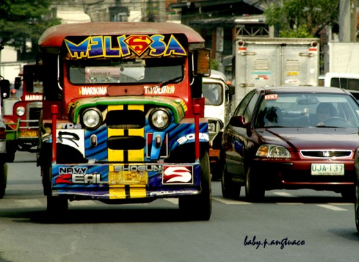 The Philippine jeepney beside a car