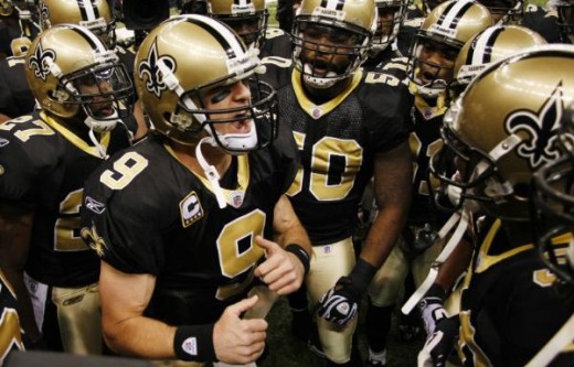 New Orleans Saints quarterback Drew Brees (9) rallies his teammates before their NFL football game against the New England Patriots, Monday, Nov. 30, 2009, in New Orleans. (AP Photo/Dave Martin)