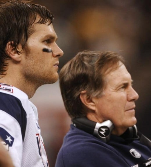 Tom Brady, left watches from the sidelines with head coach Bill Belichick during the fourth quarter of an NFL football game against the New Orleans Saints, Monday, Nov. 30, 2009, in New Orleans. (AP Photo/Dave Martin)