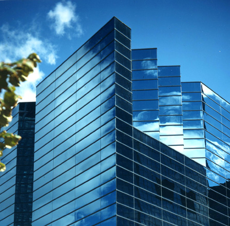 Blue reflective glass, horizontally banded creates an articulated skyline.