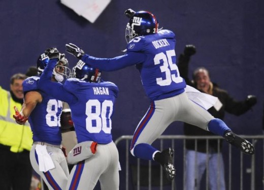 Kevin Dockery (35) and wide receiver Derek Hagan (80) congratulate wide receiver Domenik Hixon (87), left, after he ran a 79-yard punt return for a touchdown in the fourth quarter of an NFL football game against the Dallas Cowboys at Giants Stadium i