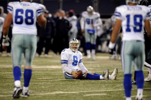 Tony Romo (9) sits on the field after getting sacked in the second quarter of an NFL football game against the New York Giants at Giants Stadium in East Rutherford, N.J., Sunday, Dec. 6, 2009. The Giants won the game 31-24. (AP Photo/Bill Kostroun)