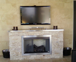 Custom built vent free fireplace with split marble and stainless steel accents.