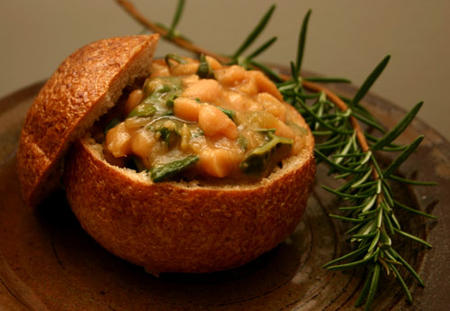 cannellini bean soup with collard greens in a bread bowl