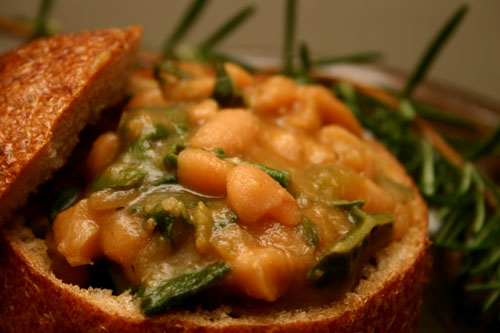 cannellini bean soup with collard greens in a bread bowl