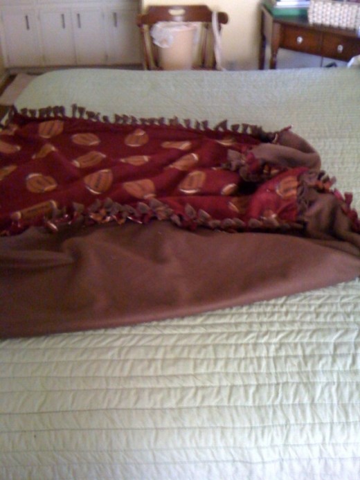 Notice the ties reflect the opposite pattern on each side of the blanket.  The brown shows the print and so on.