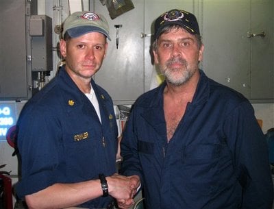Maersk-Alabama Capt. Richard Phillips, right, shakes hands with Lt. Cmdr. David Fowler, executive officer of USS Bainbridge after being rescued by U.S Naval Forces, April 12, 2009.