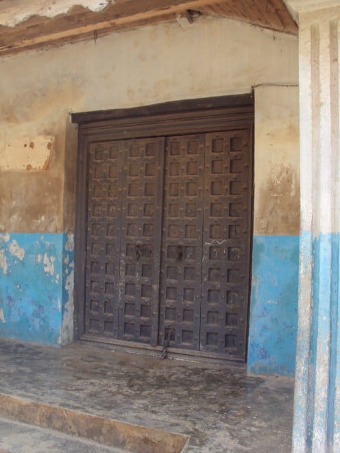 Beautiful old carved wooden doors set on dilapidated buildings