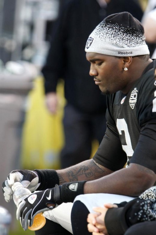 Oakland Raiders quarterback JaMarcus Russell (2) sits on the bench in the fourth quarter of an NFL football game against the Baltimore Ravens in Oakland, Calif., Sunday, Jan. 3, 2010. The Ravens won 21-13. (AP Photo/Paul Sakuma)