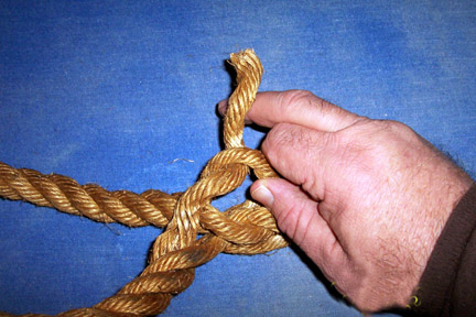 Take the strand next to first one, twist apart the shaft and push the second strand from end of the rope under the raised loop.