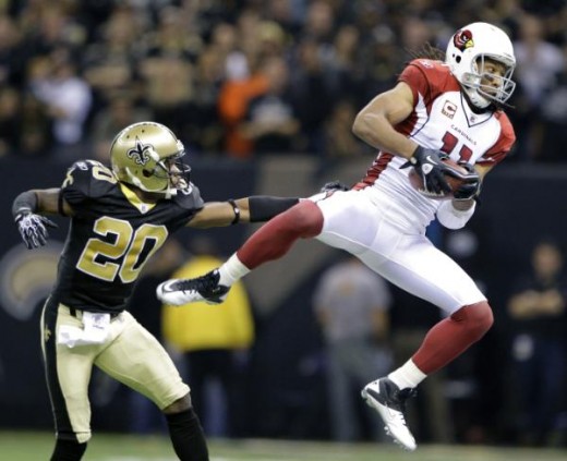 Arizona Cardinals wide receiver Larry Fitzgerald (11) catches a pass with New Orleans Saints cornerback Randall Gay (20) defending during the second quarter of an NFL football divisional playoff game in New Orleans, Saturday, Jan. 16, 2010. (AP Photo
