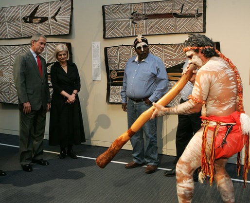 President George W. Bush at a performance of Aboriginal song and dance 9/6/2007 at the Australian National Maritime Museum, Sydney. The performer to the right is playing a traditional diggeridoo.