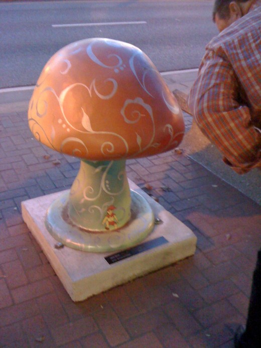 Mushroom statue on the sidewalk.