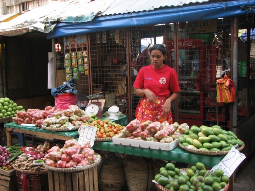 A vendor at her stand waiting for customers