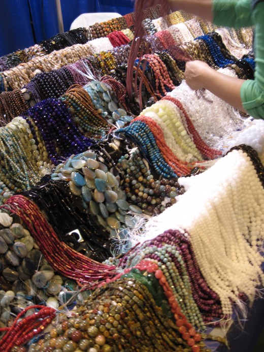 Beads on sale at Tucson Gem Show by an individual who makes his living buying beads from a factory in Hong Kong and selling them at fairs and festivals.