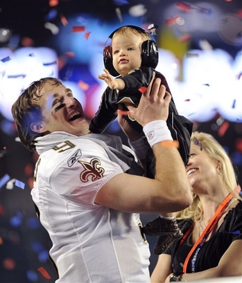 AP  New Orleans Saints quarterback Drew Brees celebrates with his son Baylen and wife Brittany after winning the Super Bowl.