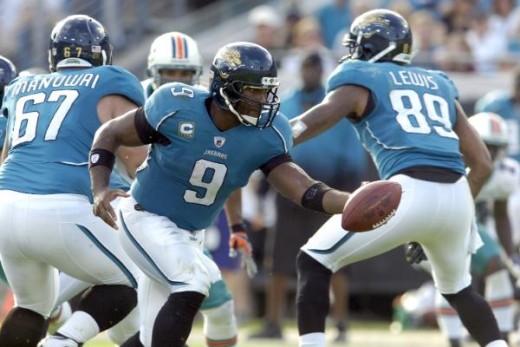 Jacksonville Jaguars quarterback David Garrard hands the ball off against the Miami Dolphins defense during an NFL football game, Sunday, Dec. 13, 2009 in Jacksonville, Fla. (AP Photo/Stephen Morton)