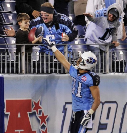 Tennessee Titans cornerback Cortland Finnegan (31) gives the football to a young fan after Finnegan intercepted a pass  Dec. 13, 2009, in Nashville, Tenn.  (AP Photo/John Russell)