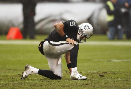 Oakland Raiders quarterback Bruce Gradkowski (5) gets up from the field after injuring his leg against the Washington Redskins in the second quarter of an NFL football game in Oakland, Calif., Sunday, Dec. 13, 2009. (AP Photo/Ben Margot)