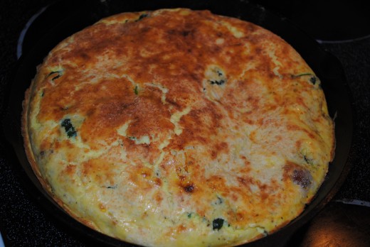 Frittata with spinach, bacon, onion and cheese, hot and fresh from the oven.