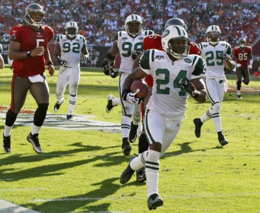 New York Jets cornerback Darrelle Revis (24) runs after intercepting a fourth-quarter pass by Tampa Bay Buccaneers quarterback Josh Freeman (5) during an NFL football game Sunday, Dec. 13, 2009, in Tampa, Fla. The Jets won the game 26-3. (AP Photo/Ch