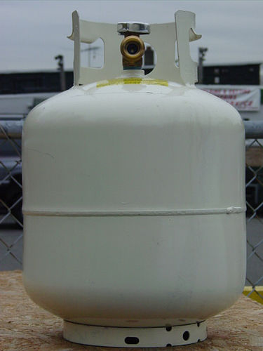 A 20 lb LP tank holds just less than 5 gallons of propane and must be fitted with several safety features including the check valve, opd and reverse seal check.