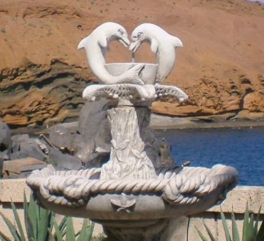 Dolphin fountain outside Flicks bar with the Yellow Mountain in the background.