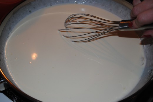 Add warm cream or milk, whisking constantly. The sauce will look very silky at this point.