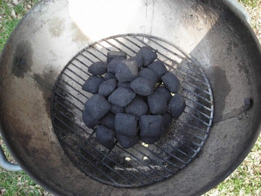 ARRANGE THE CHARCOAL IN THE CENTER OF THE GRILL