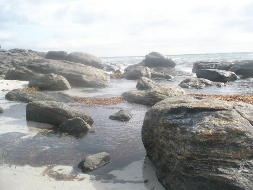 You hear the rut of the shore, the waves breaking on stone and  then a pair of smooth shaped rocks.