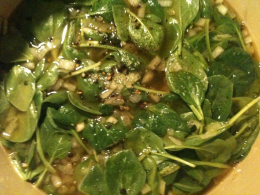 Add the chicken stock, salt and pepper, and a couple handfuls of baby spinach.