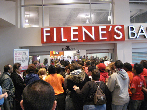 The crowd eagerly awaits the start of the gown sale.