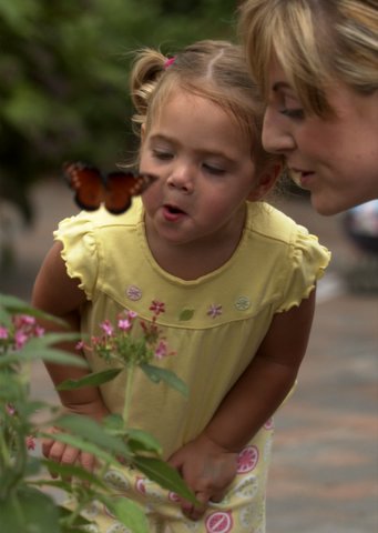 girl with her mom and a butterfly