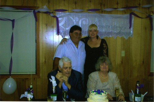 Me and my husband with my parents. Six months later my husband would be sentenced to 10 1/2 years in Federal Prison.