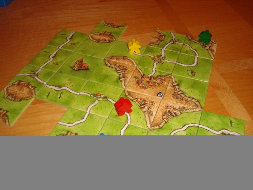 Sample Carcassonne game with "Meeples"
