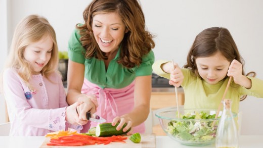 mom and kids preparing meal, just be careful when using knives with children in the kitchen