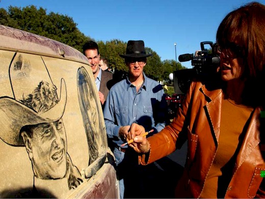 Linda Gray signs her portrait