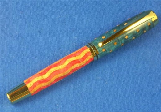 US Flag: The wood is dyed curly maple. The stars are actually cut by a laser and  inlaid into star cut pockets. Yes, there are 50 stars. The stripes are also cut by a laser then glued together prior to turning.