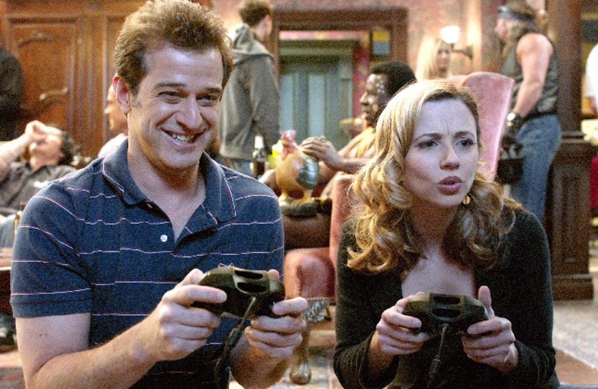 Alex and Samantha play a video game at a party.