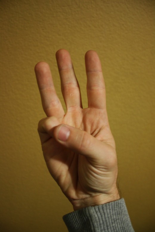 Pinky and thumb meet.