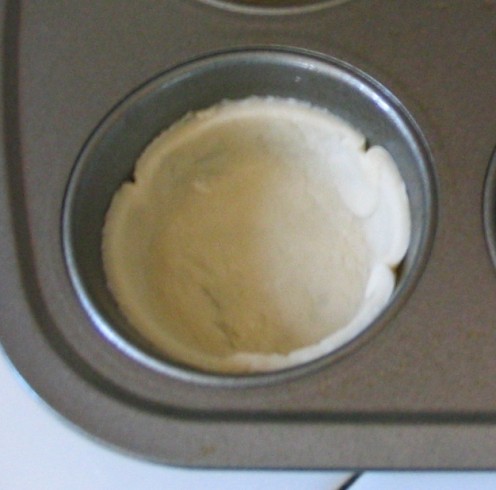 Lightly mold dough to bottom and sides of muffin cup.