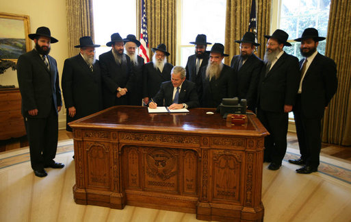 With Chabad rabbis from across the world looking on, President George W. Bush signs a presidential proclamation in honor of the 2008 Education and Sharing Day, and highlighting the important work of the Chabad Lubavitch movement.