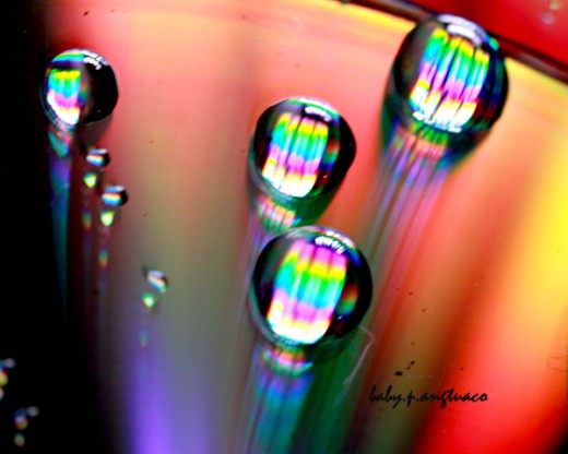 rainbow colors on water drops and cd