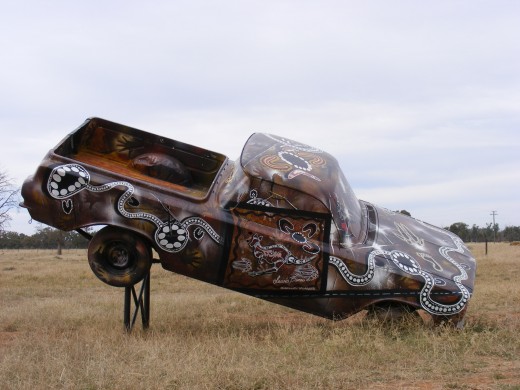 This is a 1964 EH Holden ute There was no plaque to identify the Artist of this Instillation, a great example of Indigenous Art.