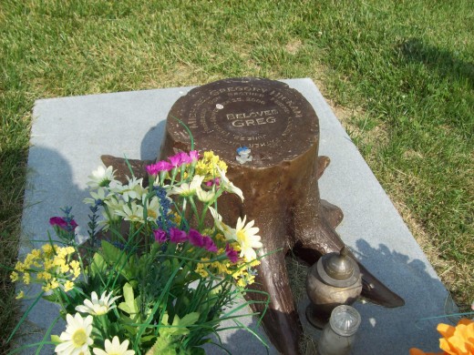 A unique marker.  The tree stump symbolizes a life cut short
