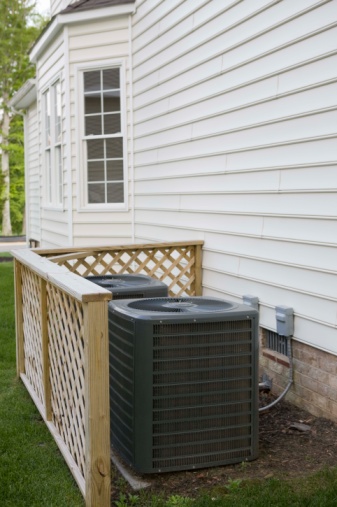 A central air conditioning unit located outside a house. Central Air conditioning provides an consistent temperature within your home
