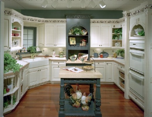 white kitchen cabinets, wood floor, teal walls, island