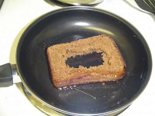 Because there's no space on the pan for the second slice, it is added on top of the first one for a 1 inch tall sandwich