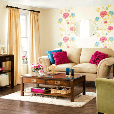 A contemporary twist in a traditional living room, accomplished with the use of supersized florals on the wall, bright pillows, neutral floors to keep it grounded.