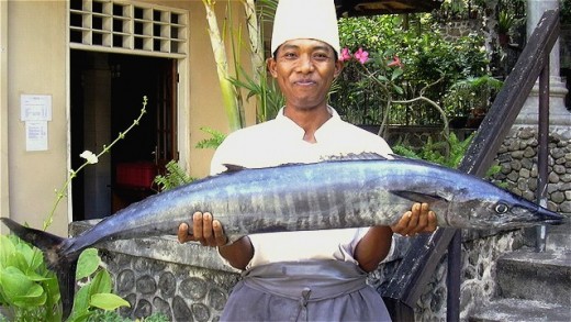A kitchen-staff from Lombok, West Nusa Tenggara, Indonesia with his big Tengiri Fish asmara-group.com